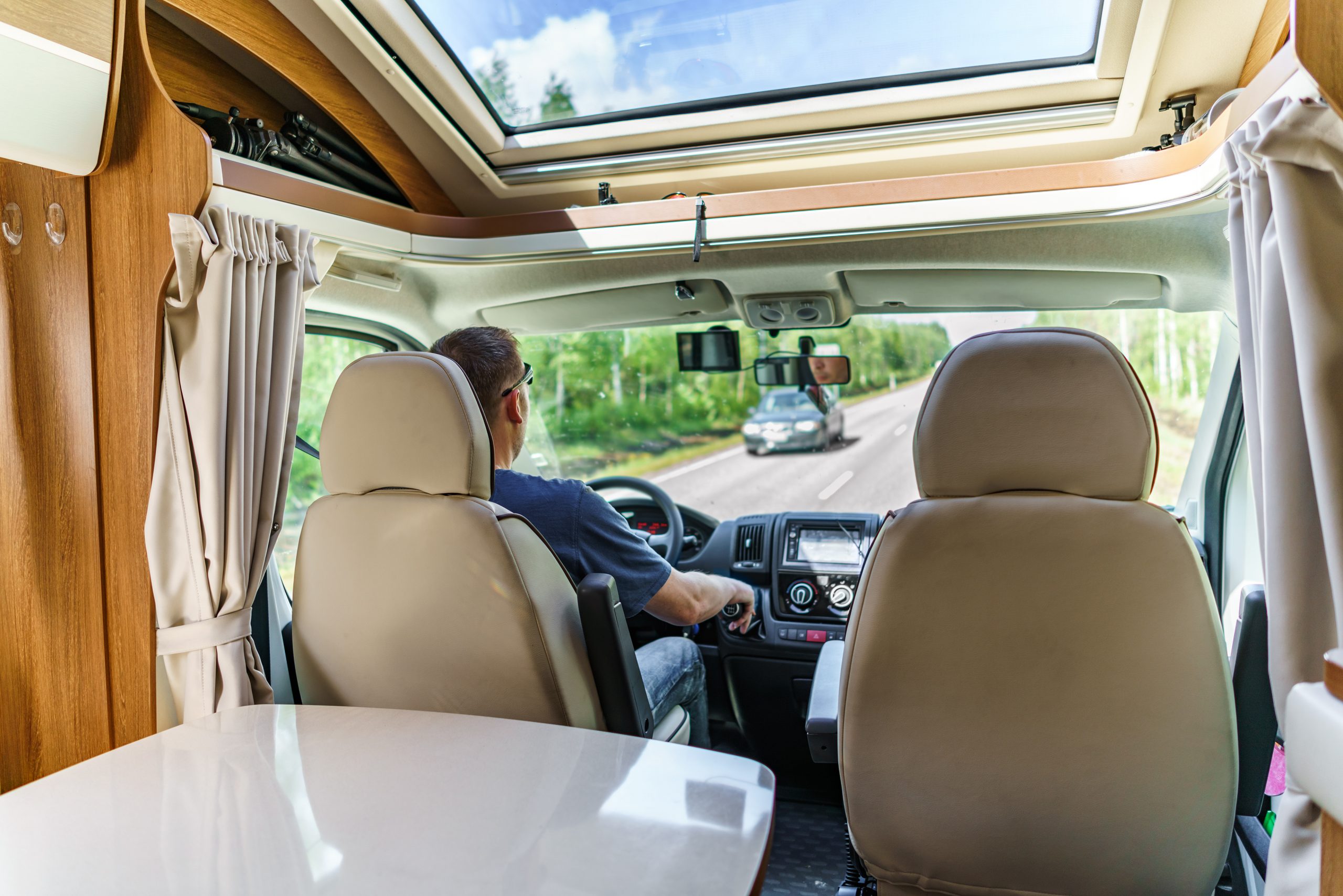 Man driving on a road in the Camper Van